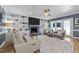 Stylish living room with custom built-in shelving, cozy seating, and an inviting fireplace at 8808 Colesbury Dr, Raleigh, NC 27615