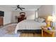 Bright main bedroom with wood flooring, ceiling fan and large area rug at 8808 Colesbury Dr, Raleigh, NC 27615
