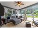 Bright sunroom with tile flooring and sliding glass doors leading to a backyard deck at 8808 Colesbury Dr, Raleigh, NC 27615