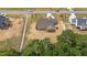 Aerial view showcases backyard with a screened porch of this well-maintained home, offering privacy and space at 90 Lane Farms Way Way, Holly Springs, NC 27540