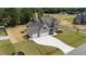 An aerial view showcases this home's three-car garage and generous lot size in a desirable neighborhood at 90 Lane Farms Way Way, Holly Springs, NC 27540