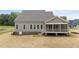 Picture of the backyard featuring a screened porch, large windows and a basement door at 90 Lane Farms Way Way, Holly Springs, NC 27540