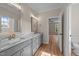 A bathroom with a double vanity and a view of the bedroom at 90 Lane Farms Way Way, Holly Springs, NC 27540
