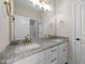 Bathroom featuring dual sinks, granite countertops, gold fixtures, and vanity lighting for a modern touch at 90 Lane Farms Way Way, Holly Springs, NC 27540