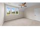 Bright bedroom with neutral carpet, ceiling fan and large windows offering serene views at 90 Lane Farms Way Way, Holly Springs, NC 27540