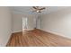 A spacious bedroom featuring wood flooring, ceiling fan, and dual closets at 90 Lane Farms Way Way, Holly Springs, NC 27540