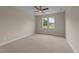 Bright bedroom with tan carpet, ceiling fan, and double windows at 90 Lane Farms Way Way, Holly Springs, NC 27540