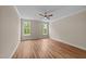 A spacious bedroom featuring wood flooring, a ceiling fan, and natural light at 90 Lane Farms Way Way, Holly Springs, NC 27540