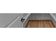 A view into closet with wood flooring and black door hardware in the house at 90 Lane Farms Way Way, Holly Springs, NC 27540