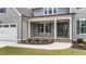 Detailed front porch featuring double doors and manicured landscaping enhances the home's welcoming curb appeal at 90 Lane Farms Way Way, Holly Springs, NC 27540