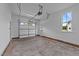 A large garage with concrete floors, a roll up door, and window at 90 Lane Farms Way Way, Holly Springs, NC 27540