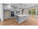 Modern kitchen showcasing gray cabinets, stainless steel appliances, and a center island at 90 Lane Farms Way Way, Holly Springs, NC 27540