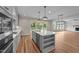 Gourmet kitchen featuring gray cabinets, a center island, and stainless appliances at 90 Lane Farms Way Way, Holly Springs, NC 27540
