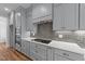 Contemporary kitchen showcasing gray cabinets, subway tile backsplash, and modern appliances at 90 Lane Farms Way Way, Holly Springs, NC 27540