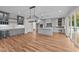 Spacious kitchen featuring gray cabinets, quartz countertops, a wine cooler, and wood flooring at 90 Lane Farms Way Way, Holly Springs, NC 27540