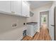 Well-organized laundry room with white cabinets, gray countertop, and convenient utility connections at 90 Lane Farms Way Way, Holly Springs, NC 27540