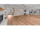 An expansive living area featuring hardwood floors, a fireplace, and an open design flowing into the kitchen at 90 Lane Farms Way Way, Holly Springs, NC 27540