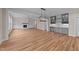 Open-concept living room with a fireplace, built-in shelves, and a wet bar at 90 Lane Farms Way Way, Holly Springs, NC 27540