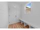 Mud room features built-in bench, wood-look flooring, and white shiplap walls at 90 Lane Farms Way Way, Holly Springs, NC 27540