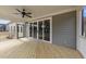 Relaxing covered patio with ceiling fan and sliding glass doors offers seamless indoor-outdoor living at 90 Lane Farms Way Way, Holly Springs, NC 27540
