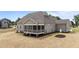 Side and rear exterior featuring a screened porch, well-manicured landscaping, and a neutral color palette at 90 Lane Farms Way Way, Holly Springs, NC 27540