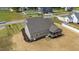View of the home's rear exterior, showcasing its screened porch, well-maintained lawn, and a privacy fence at 90 Lane Farms Way Way, Holly Springs, NC 27540