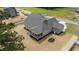 Expansive home with a screened porch, mature landscaping, and neutral siding under a dark gray roof at 90 Lane Farms Way Way, Holly Springs, NC 27540