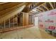 Spacious unfinished attic space showing wood framing and pink insulation at 90 Lane Farms Way Way, Holly Springs, NC 27540