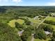 Expansive aerial view showcasing a sprawling property with lush greenery, surrounded by trees and open spaces at 913 Milton Rd, Durham, NC 27712