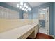 Bathroom with an expansive counter, large mirror, and a tiled shower in the adjacent space at 913 Milton Rd, Durham, NC 27712