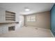 Bedroom with built-in shelving and desk area, and a large window providing natural light at 913 Milton Rd, Durham, NC 27712
