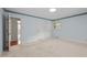 Bedroom featuring neutral carpeting, a double closet, and light blue wall paint at 913 Milton Rd, Durham, NC 27712