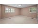 Neutral bedroom with carpeted floor and two windows overlooking the side yard at 913 Milton Rd, Durham, NC 27712