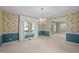 Formal dining room featuring elegant wallpaper, white trim, and a decorative chandelier, perfect for hosting dinners at 913 Milton Rd, Durham, NC 27712