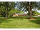 Spacious brick home nestled among mature trees, offering a serene and private setting on a sprawling lawn at 913 Milton Rd, Durham, NC 27712