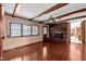 Comfortable living room with wood floors, brick fireplace and wood beam ceiling accents at 913 Milton Rd, Durham, NC 27712