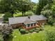 Aerial view of home featuring a backyard deck perfect for entertaining and surrounded by lush greenery and mature trees at 913 Milton Rd, Durham, NC 27712