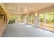 Bright sunroom with multiple glass doors, offering views of the outdoor deck and yard at 913 Milton Rd, Durham, NC 27712