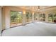 Large sunroom with multiple sliding glass doors to the backyard and a carpeted floor at 913 Milton Rd, Durham, NC 27712