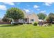 The backyard features a patio, well manicured lawn, mature trees, and an outdoor cooking area at 1001 Pasture View Ln, Raleigh, NC 27603