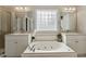 Luxurious bathroom with a jetted tub, double vanity sinks, and a separate shower at 1001 Pasture View Ln, Raleigh, NC 27603