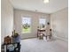 This bedroom features a small desk, decor, two windows overlooking the yard, neutral walls and carpeted floor at 1001 Pasture View Ln, Raleigh, NC 27603
