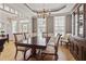 Spacious dining room featuring a hardwood floor, chandelier, and large windows that fill the room with natural light at 1001 Pasture View Ln, Raleigh, NC 27603