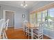 Charming dining area with wood floors, a bright window, and a classic table set at 1001 Pasture View Ln, Raleigh, NC 27603