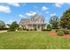 Charming two-story home boasts a manicured lawn, beautiful landscaping, and a welcoming front porch at 1001 Pasture View Ln, Raleigh, NC 27603