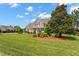 Beautifully landscaped front yard showcasing a two-story home with a welcoming porch and manicured lawn at 1001 Pasture View Ln, Raleigh, NC 27603