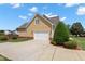 Attached two-car garage and driveway, with manicured landscaping, offering convenience and curb appeal at 1001 Pasture View Ln, Raleigh, NC 27603