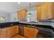 Open kitchen featuring granite countertops, stainless steel appliances, tile backsplash, and wood cabinets at 1001 Pasture View Ln, Raleigh, NC 27603