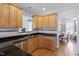 Close-up of a kitchen with granite countertops, stainless appliances, and wood cabinetry at 1001 Pasture View Ln, Raleigh, NC 27603