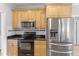 Kitchen features stainless steel appliances, granite countertops, and classic wood cabinetry at 1001 Pasture View Ln, Raleigh, NC 27603